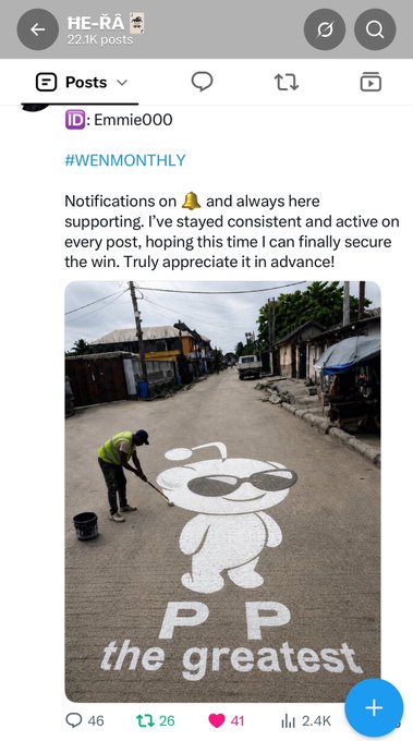 A screenshot of a social media post from user 'HE-RA' (22.1K points) by 'Emmie000' tagged '#WENMONTHLY,' asking for support to secure a win, featuring an image of a person in a yellow shirt painting a 'PP the greatest' mascot design on a street.
