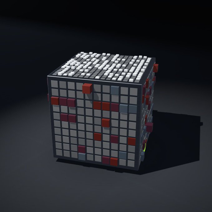 A 3D rendered cube with a grid texture on all faces has red, blue, and gray square blocks protruding from its surfaces.