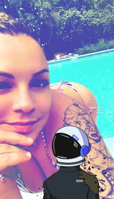 Poolside selfie of a woman with tattoos, overlaid with an astronaut cartoon avatar wearing a '404' shirt.