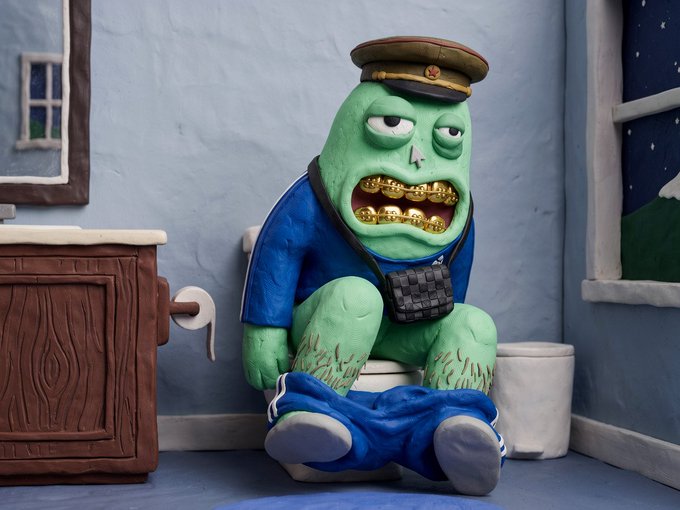 A green, zombie-like figurine with gold grills and a military cap sits on a toilet, humorously depicting the "Extracturds" NFT collection referenced in the post—a playful riff on extractive crypto culture with "10k" being the standard NFT collection size.