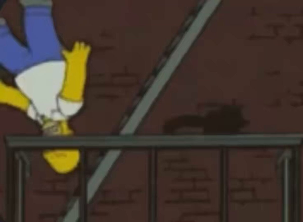 The image features a man dressed as Homer Simpson, who appears to be hanging upside down from an ironing board or ladder while wearing a white shirt and blue jeans. The scene takes place against a brick wall backdrop, which adds to the overall visual appeal of the image. The caption "Nobody: Bitcoin" suggests that there might be some connection between the man's actions in the image and the concept of Bitcoins, although it is unclear how they are related or if this is just a coincidence.
