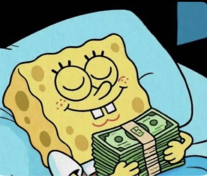 A meme image of SpongeBob SquarePants contentedly holding a large stack of money while lying in bed.