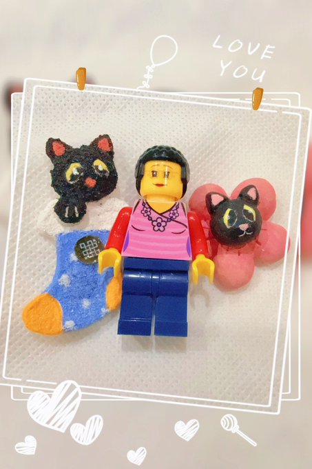A LEGO minifigure is posed alongside two small cat figurines and a blue sock, with "LOVE YOU" written in the corner and decorative hearts drawn around the border. The image appears unrelated to the post about blockchain protocols and smart contract inference—it seems to be a personal or decorative photo mistakenly attached to the technical content about Ritual and ONNX inference.