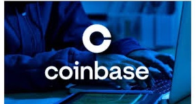 The image shows a person's hands typing on a laptop with the white "coinbase" logo and "C" symbol overlaid, tinted in a blue filter. This relates to the post by illustrating Coinbase's digital platform involvement in helping Singapore police stop over $4.2 million in crypto scam losses and protect 145+ potential victims.