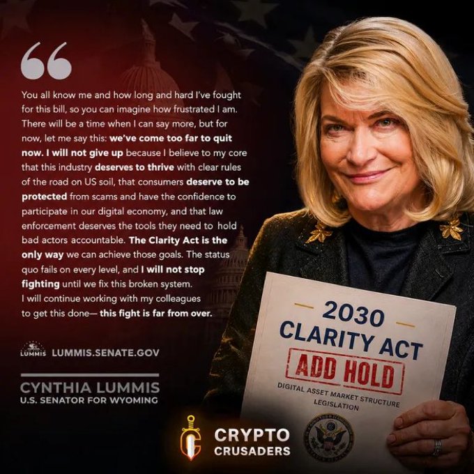 Senator Cynthia Lummis (R-Wyoming) is pictured holding a sign reading "2030 CLARITY ACT — ADD HOLD — DIGITAL ASSET MARKET STRUCTURE LEGISLATION," alongside a quoted statement vowing to keep fighting for the bill. The image directly supports the post's message, emphasizing her commitment to passing the Clarity Act for crypto market regulation, with a "Crypto Crusaders" logo highlighting the call for $XRP and broader crypto clarity.