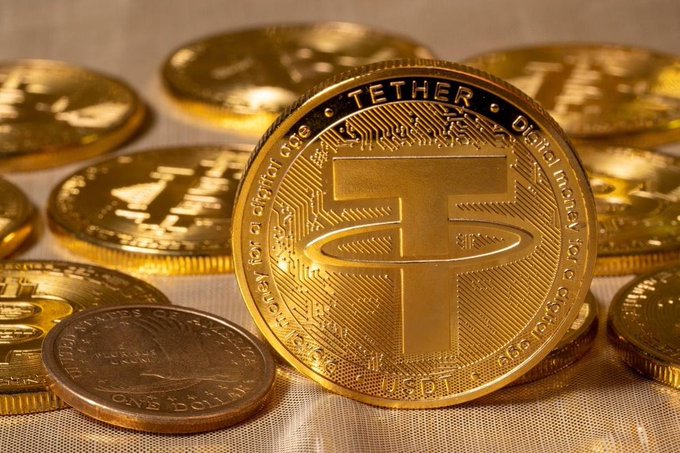 A stack of gold Tether (USDT) coins sits prominently in the foreground with a U.S. quarter for scale, while additional USDT tokens are scattered in the background. The image visually represents the cryptocurrency mentioned in the post, which details Tether's largest burn operation since February, eliminating 2.5 billion USDT from the Ethereum network.
