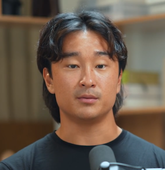 A close-up of an East Asian man speaking into a microphone, with a neutral, slightly regretful expression on his face.

The image fits the post's theme of regret, as the man's somber, contemplative look seems to capture the silent sigh of someone reflecting on missed investment gains from the Trump memecoin.