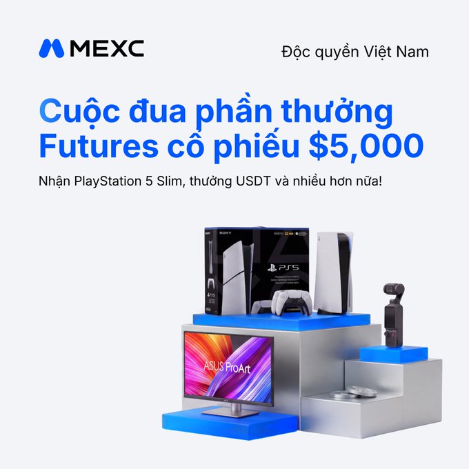 A Vietnamese promotional banner from MEXC advertising a 'Cuộc đua phần thưởng Futures cổ phiếu $5,000' (Futures stock reward race $5,000), featuring images of a PlayStation 5, an ASUS ProArt monitor, and other prizes.