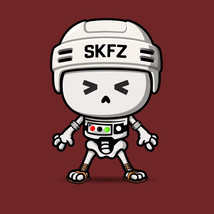 A cartoon mascot of a small white robot-like figure wearing a helmet labeled 'SKFZ', with a control panel on its chest, set against a maroon background.