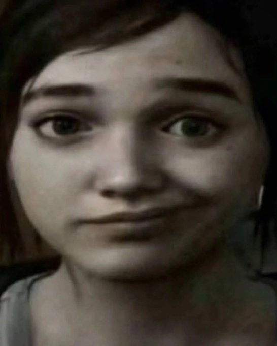 A close-up portrait photograph of a young person with dark hair, dark eyebrows, and green eyes looking directly at the camera with a slight smile.