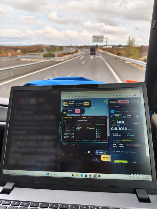 A laptop screen showing a cryptocurrency trading interface with 'BINANCE' visible sits on a passenger's lap on a bus traveling down a highway.