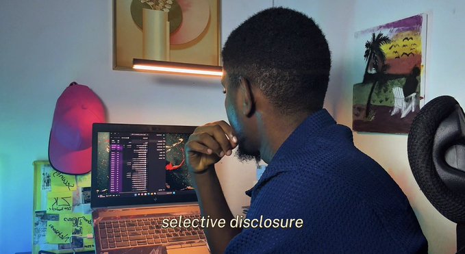 A man with a short beard sits in front of a computer monitor, looking thoughtfully at the screen, with the caption "selective disclosure" overlaid at the bottom.