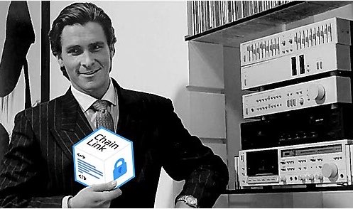 A black-and-white photograph of a man in a pinstripe suit holding a small box labeled "Chain Link".