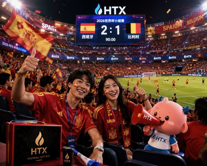 A promotional image showing two fans in Spain jerseys at a 2026 World Cup match against Belgium (final score 2:1), with HTX branding and a mascot holding a megaphone.