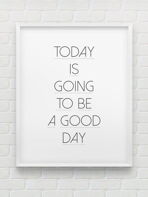 A framed print on a white brick wall displays the motivational phrase "TODAY IS GOING TO BE A GOOD DAY" in black capital letters, reinforcing the post's message of starting the week with positivity and resilience.