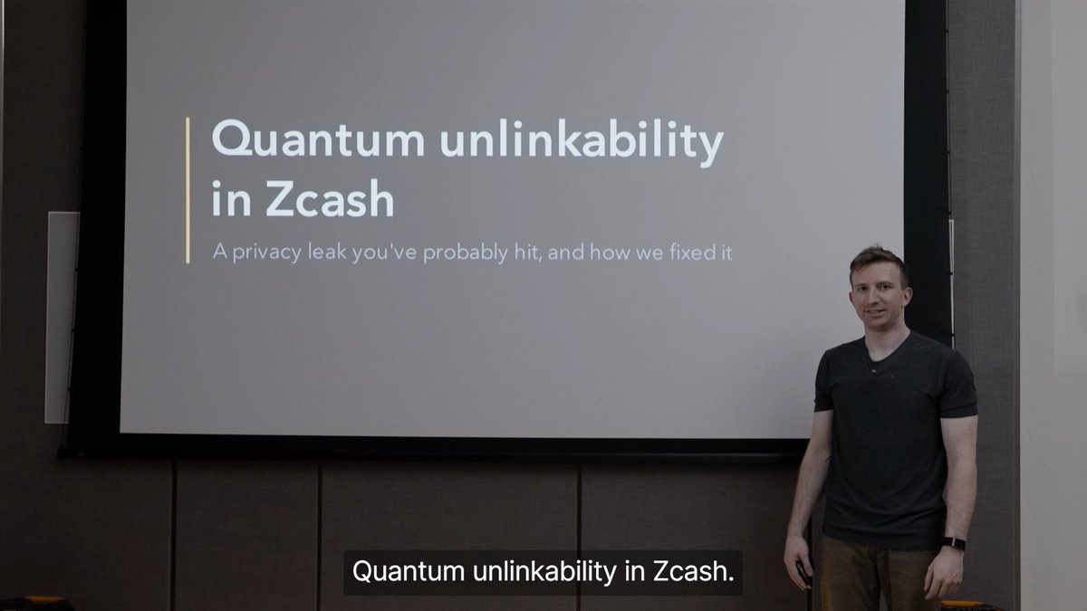 A presenter stands beside a slide titled "Quantum unlinkability in Zcash" with the subtitle "A privacy leak you've probably hit, and how we fixed it," illustrating his talk on the quantum privacy vulnerability of sharing shielded addresses and the one-time IVK solution.