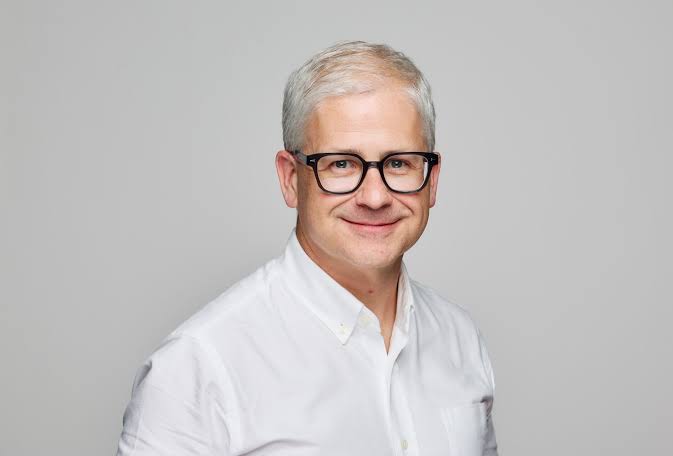 A professional headshot of a smiling man with gray hair wearing black-rimmed glasses and a white button-down shirt against a gray background. The image accompanies an announcement highlighting Patrick McHenry's endorsement of the CLARITY Act as a historic technology bill with major implications for XRP and crypto in the United States.