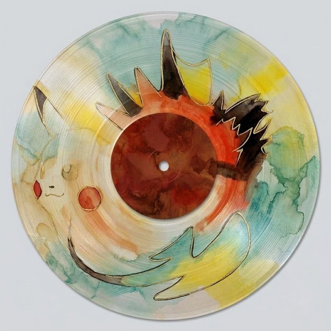 A vinyl record featuring watercolor artwork of a Pokémon scene with Pikachu and what appears to be a Cyndaquil, with golden line details on the label.