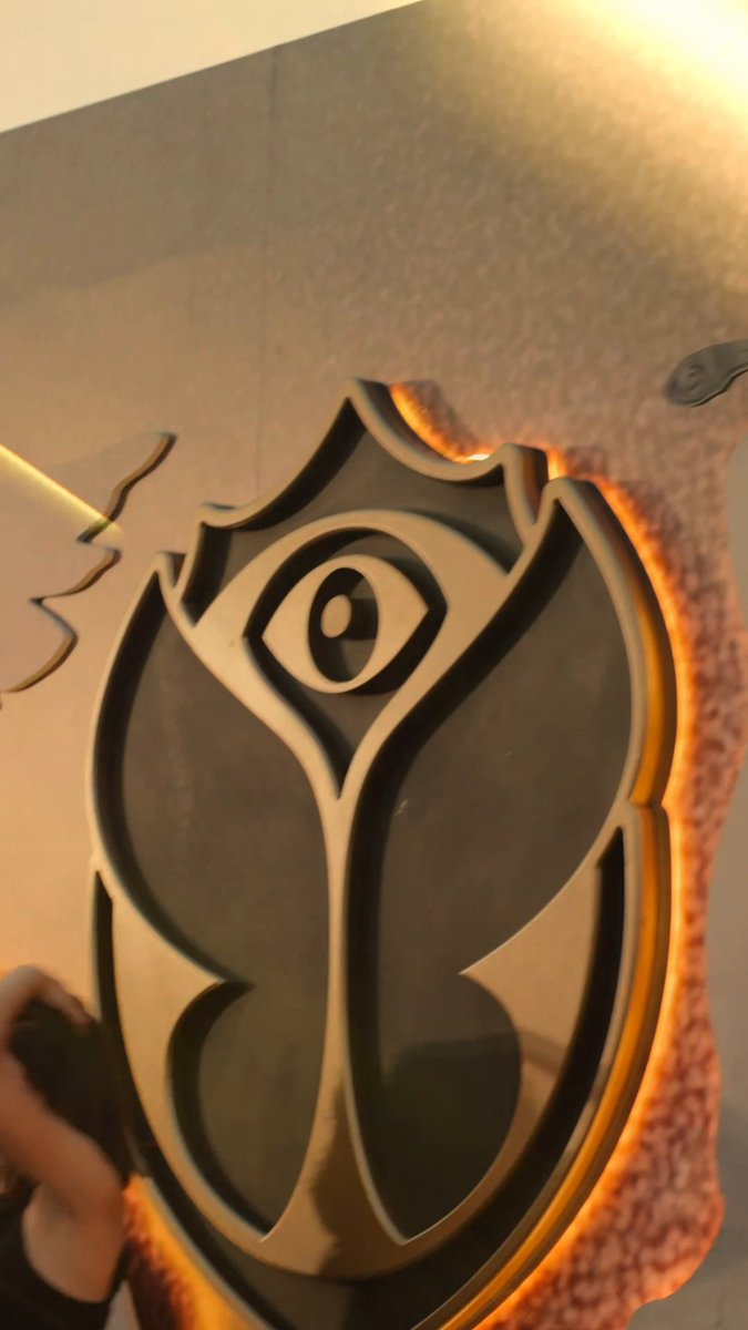 The image shows a stylized rose logo with an eye in the center, possibly representing a festival or brand associated with nightlife. This visual connects to the Bybit Card's message of keeping up with you wherever the night takes you.