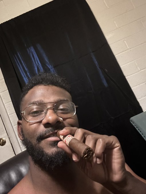 The image features a man with glasses holding a cigar, possibly posing for a selfie or sharing his experience with others. The caption of the photo reads "#Day538 #apecoin A Supporting #yuga @apecoin Blessings ApE". This caption is likely related to the post about the all-time high of anapecoin and could be a reference to the popularity of the cryptocurrency, which has been gaining traction in recent years.