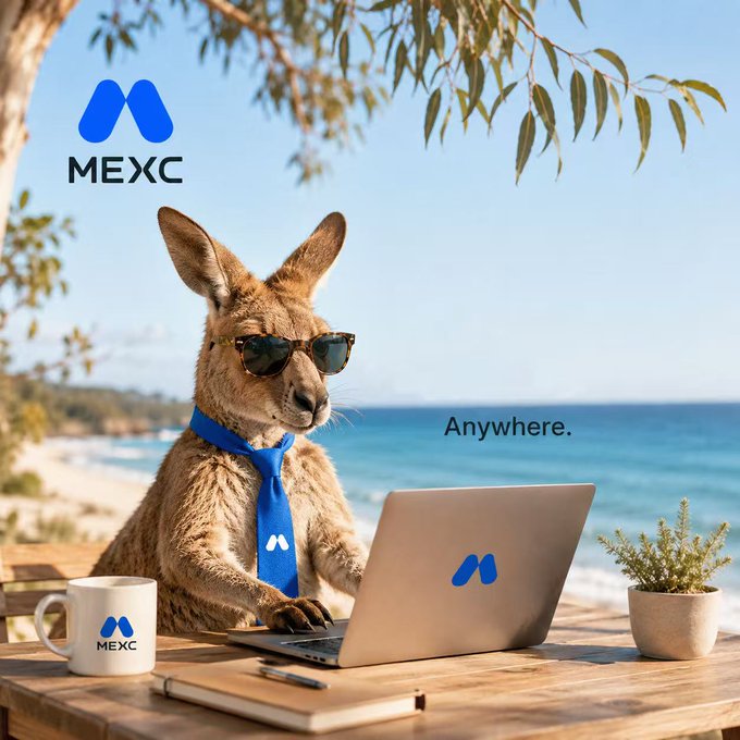An advertisement for MEXC cryptocurrency exchange features a kangaroo wearing sunglasses and a blue tie, working on a laptop at a beachside table with the slogan 'Anywhere.'