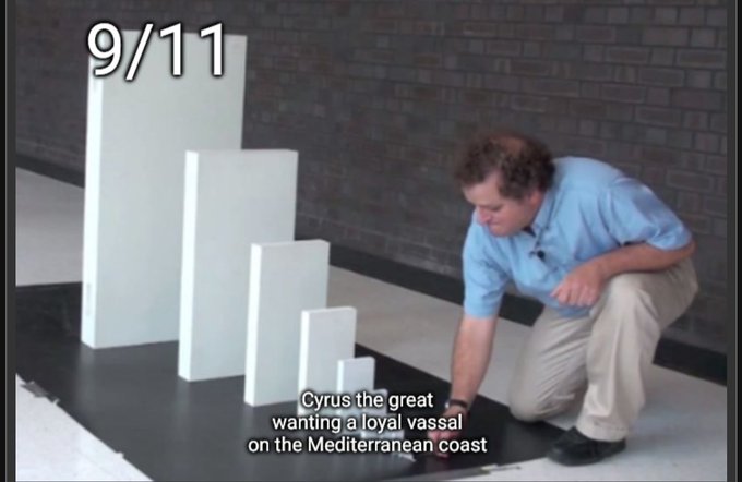 Image showing white rectangular blocks of decreasing height arranged on a black surface, with a man crouching beside them, labeled '9/11' and captioned 'Cyrus the great wanting a loyal vassal on the Mediterranean coast'.