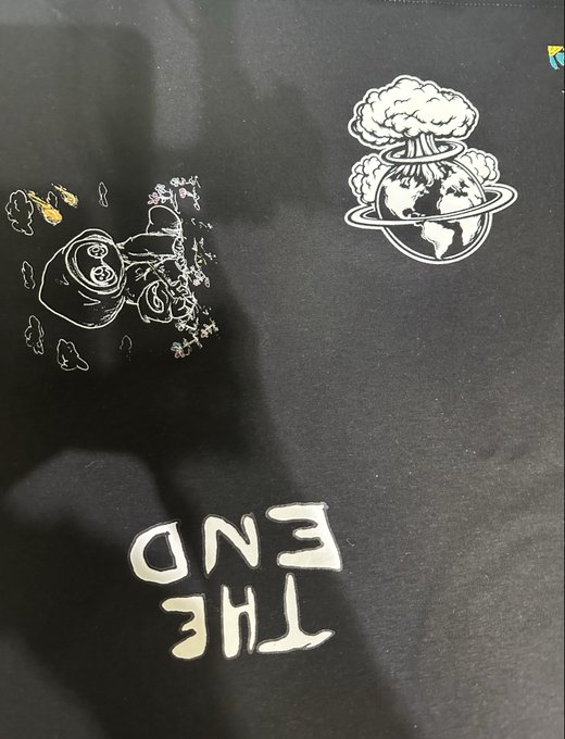 The End clothing item featuring upside-down 'THE END' text with cartoon graphics including a mushroom cloud and planet Earth.