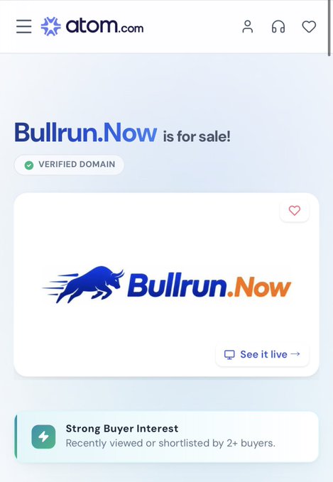 A screenshot from atom.com showing the domain 'Bullrun.Now' is for sale with a verified domain badge, featuring a blue bull mascot logo, a 'See it live' button, and a notice of 'Strong Buyer Interest' from 2+ buyers.