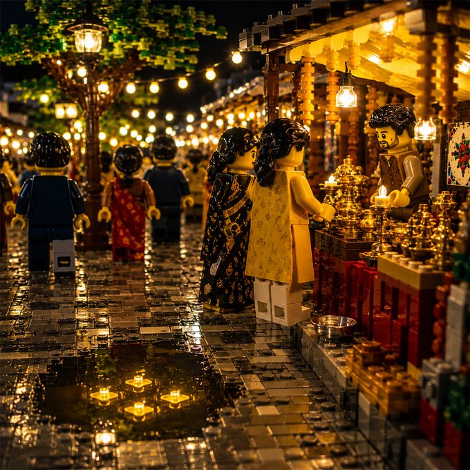 A nighttime LEGO market scene with minifigures browsing warmly-lit stalls aligns with "Built brick by brick. Growing block by block." by illustrating how small LEGO pieces come together to form a vibrant, evolving community.
