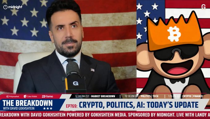 The image shows a man in a suit with an American flag background, featured on "The Breakdown" show with David Gokhshtein (EP769: Crypto, Politics, AI: Today's Update), alongside a cartoon monkey wearing a Bitcoin crown and sunglasses. The post suggests this marks the origin of the "suit and American flag" profile picture trend, implying the show's host may have popularized this now-common crypto influencer aesthetic.