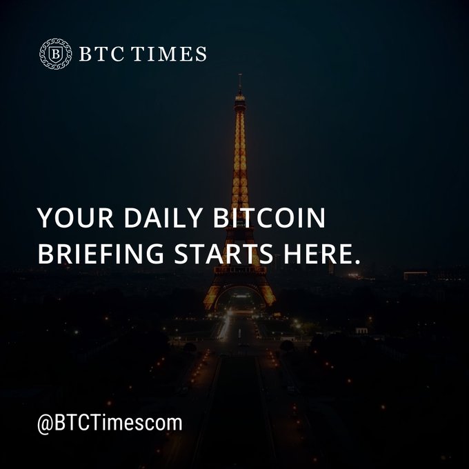 A promotional graphic for 'BTC TIMES' (@BTCTimescom) featuring the Eiffel Tower lit up at night with the text 'YOUR DAILY BITCOIN BRIEFING STARTS HERE.'