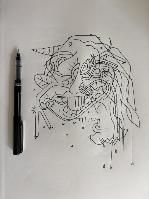 An abstract black ink line drawing on white paper shows distorted faces and geometric shapes, with a black marker resting beside it.