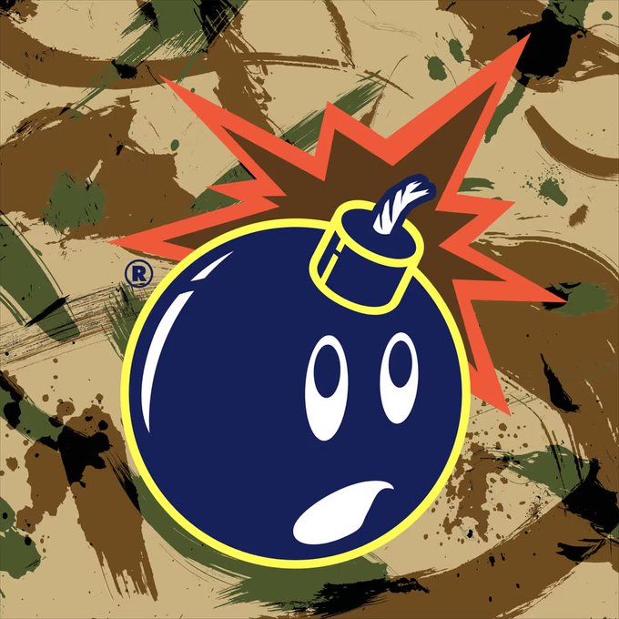 A cartoon bomb character with a shocked expression against a camouflage background with a red explosion graphic behind it, featuring a registered trademark symbol.