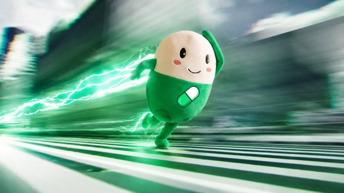 A pill-shaped mascot character with a white top and green bottom runs forward with green energy trails behind it, set against a blurred urban backdrop.