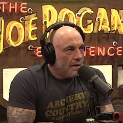 Joe Rogan is shown speaking into a podcast microphone wearing headphones, with "THE JOE ROGAN EXPERIENCE" displayed in the background. The image relates to the news of his reported $250M Spotify deal renewal, as he is the host of the popular podcast featured in the background.