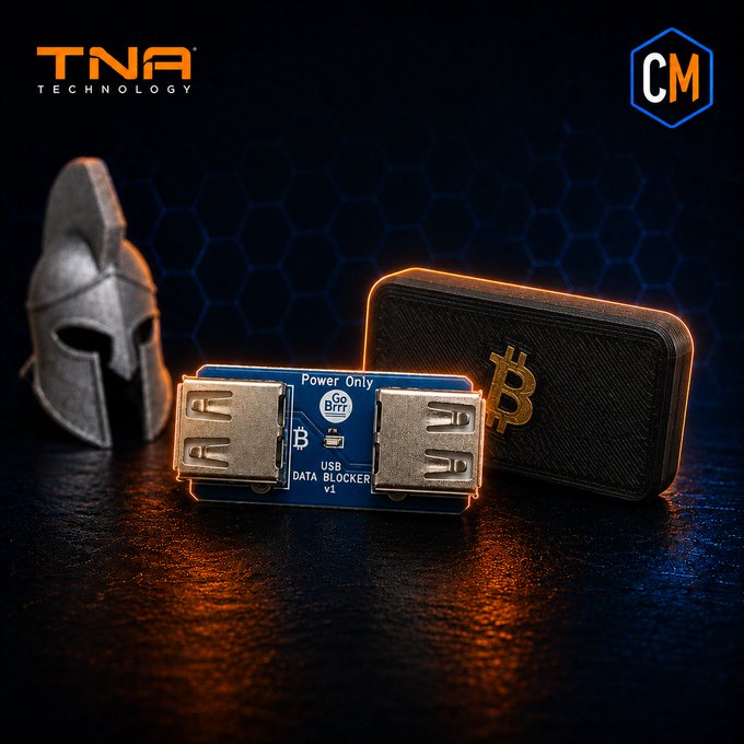 A promotional image for TNA Technology showing a 'Go Brrr' USB Data Blocker V1.1 with 'Power Only' feature next to a Bitcoin logo case and a Spartan helmet against a hexagonal blue background.