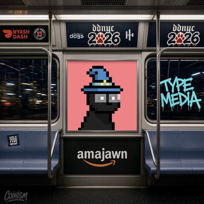 A subway car interior features various advertisements and graffiti-style text including 'NYASH DASH', 'dddnyc 2026', 'TYPE MEDIA', 'Coinism', and an Amazon logo with the word 'amajawn' beneath a pixel art character.