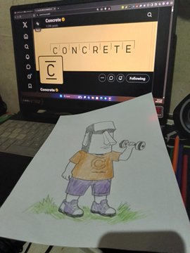A hand-drawn colored sketch of a boy in a VR headset holding a camera rests on a desk in front of a computer monitor displaying an image of the letter 'C' spelled out with scrabble tiles spelling 'CONCRETE'.