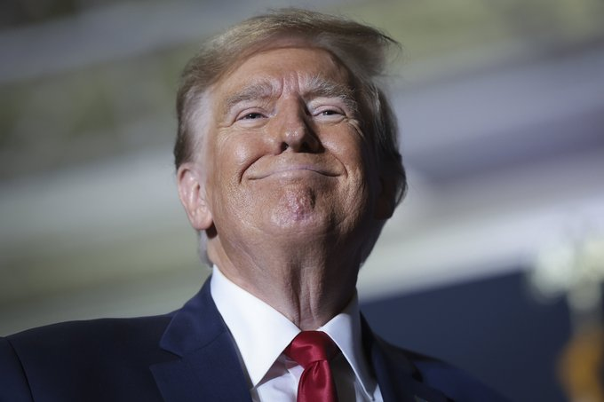 Donald Trump smiles widely in a close-up portrait, relating to the news of his alleged $635M earnings from a meme coin.