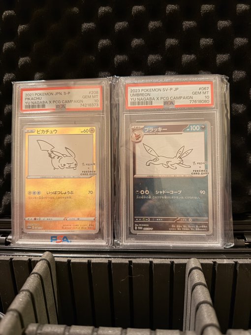 Two PSA-graded Japanese Pokémon cards featuring Pikachu (card #206) and Umbreon (card #067) from the Yo Nagaba × PCG Campaign are displayed in protective cases, both achieving GEM MT 10 status with high population numbers (74218373 and 77618080), reflecting the artist's growing collectible demand.