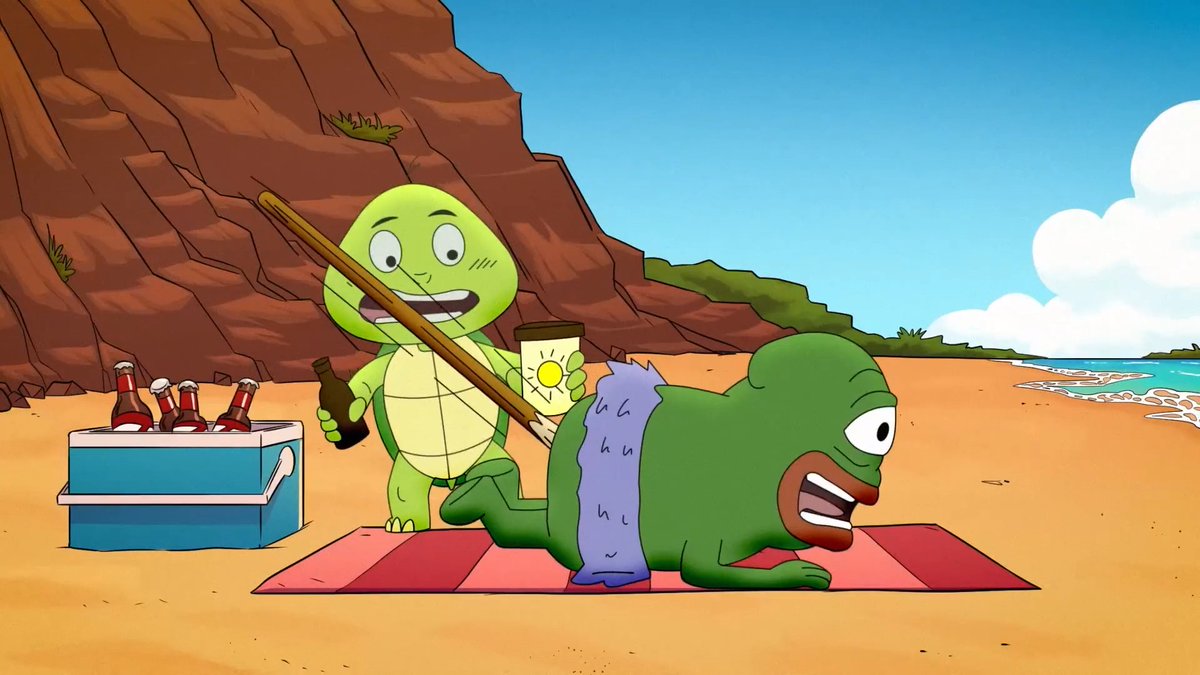 An animated cartoon scene on a beach shows a green turtle holding a stick and a bottle, standing next to a green, one-eyed creature lying on a striped towel.