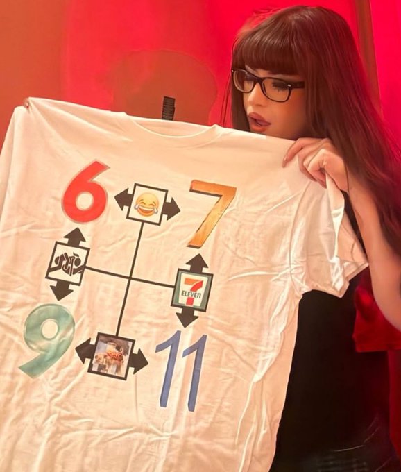A woman with glasses and bangs holding up a white t-shirt displaying a 7-Eleven themed design with the numbers 6, 7, 9, and 11 connected by arrows to 7-Eleven branded graphics.