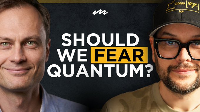 The image features two men standing next to each other, with a banner above them that reads "Should We Fear Quantum?". The man on the left has his face partially obscured by glasses, while the man on the right wears a baseball cap. They are both smiling and appear to be engaged in conversation or discussing the topic of quantum computing and Bitcoin.