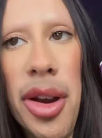A close-up of a person with long dark hair and pink-tinted lips mid-speech, conveying a serious or contemplative expression. The image pairs with commentary about the lack of "street smarts" in crypto, suggesting the person is reflecting on or critiquing common mistakes made in the cryptocurrency space.