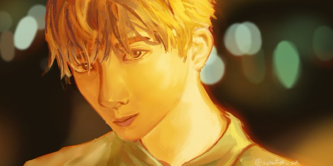 A digital illustration of a young man with short blonde hair rendered in warm golden tones against a blurred background with bokeh lights, signed by the artist.