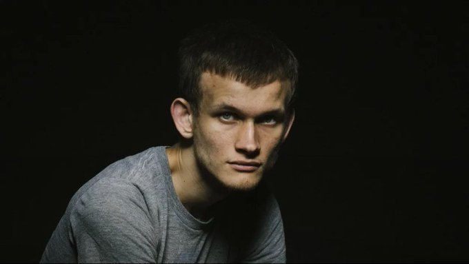 The image shows a young man with short hair wearing a gray shirt, sitting down against a black background. The photo has been edited to include a caption at the bottom of the frame that reads "Urgent Breaking News Ethereum co-founder @VitalikButerin (Vitalik Buterin), currently 32 years old, was found at his residence in Russia early on the morning of June 20."