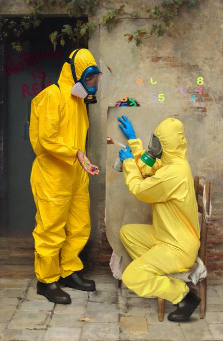 Two people in yellow hazmat suits and gas masks stand in front of a weathered wall with colorful numbers; one person holds a spray paint can while the other holds the cap.