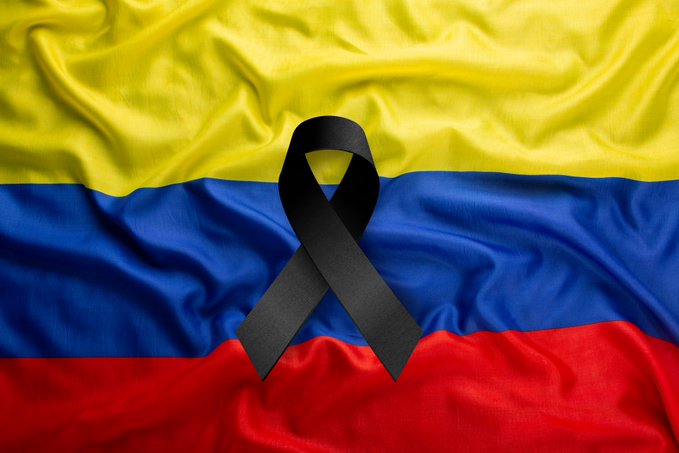 The Colombian flag (yellow, blue, and red horizontal stripes) with a black mourning ribbon overlaid in the center.