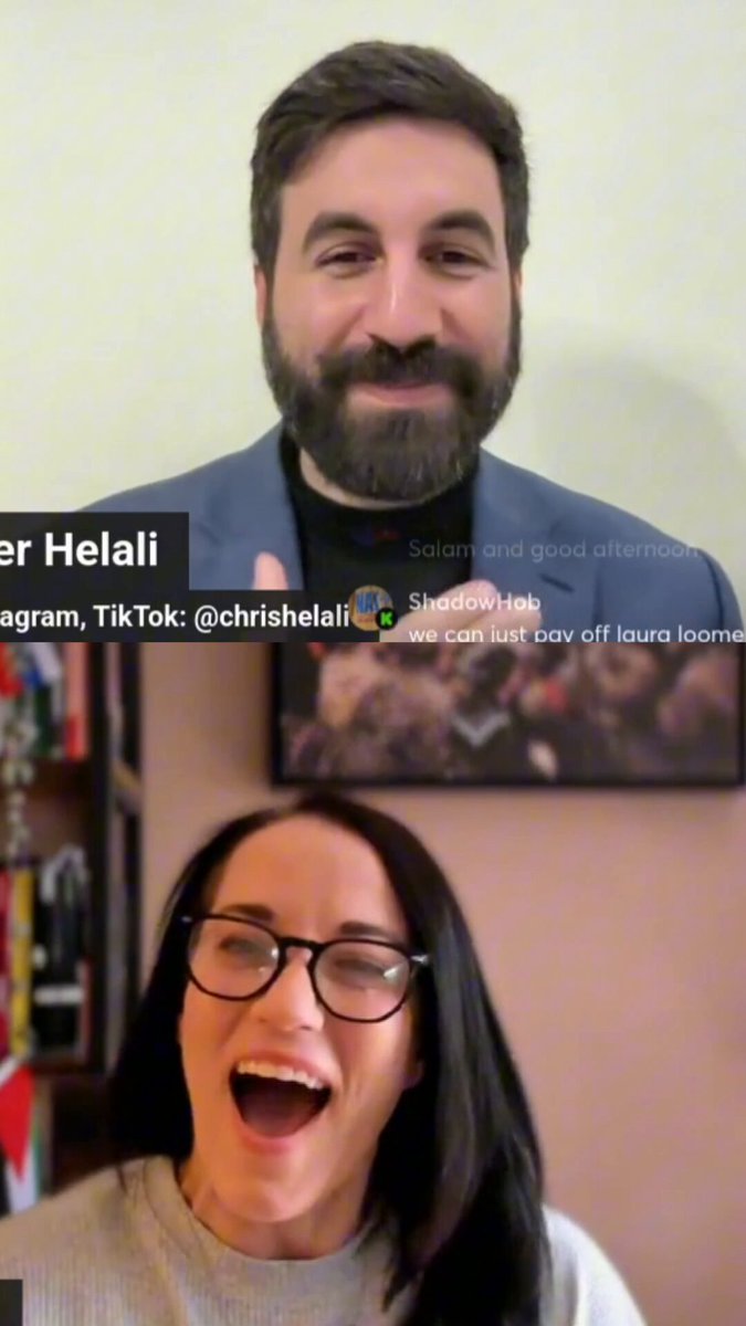 The image shows a man wearing glasses and a blue suit, smiling at the camera during an online chat with another person who has black hair and glasses. The two individuals appear to be engaged in a conversation about cryptocurrency or financial news.