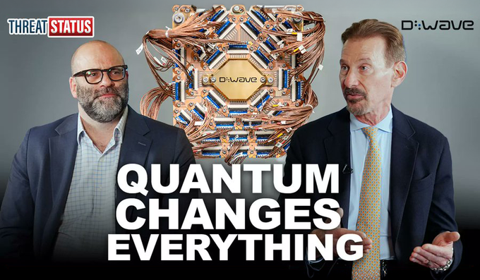 The image is a thumbnail for a "Threat Status" video featuring two men in suits discussing quantum computing, with a D-Wave quantum chip displayed between them and the bold headline "QUANTUM CHANGES EVERYTHING" overlaid at the bottom. The thumbnail visually reinforces the post's message about making quantum computing accessible, showcasing D-Wave's hardware as a tangible example of how the technology is moving beyond elite labs toward broader availability.